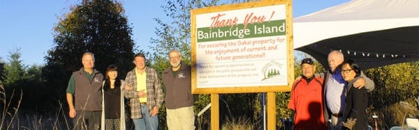 Parks Commissioners join a Sakai family member at the ceremony marking the public purchase of the Sakai family farm land,