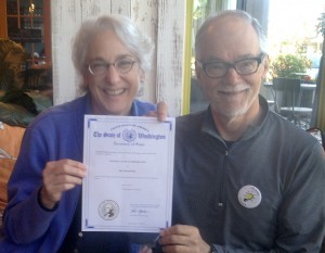 Jane Lindley and Steve Johnson display Island Power's nonprofit certificate in early 2015