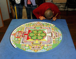 Artist at work on a sand mandala