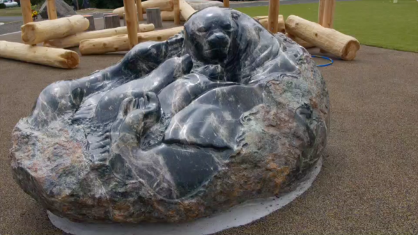 The father sea lion overlooks mom and two children in Andre Pomeroy's powerful Serpentinite stone sculpture