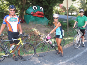 Up close and personal, cyclists see the island and pause by Frog Rock